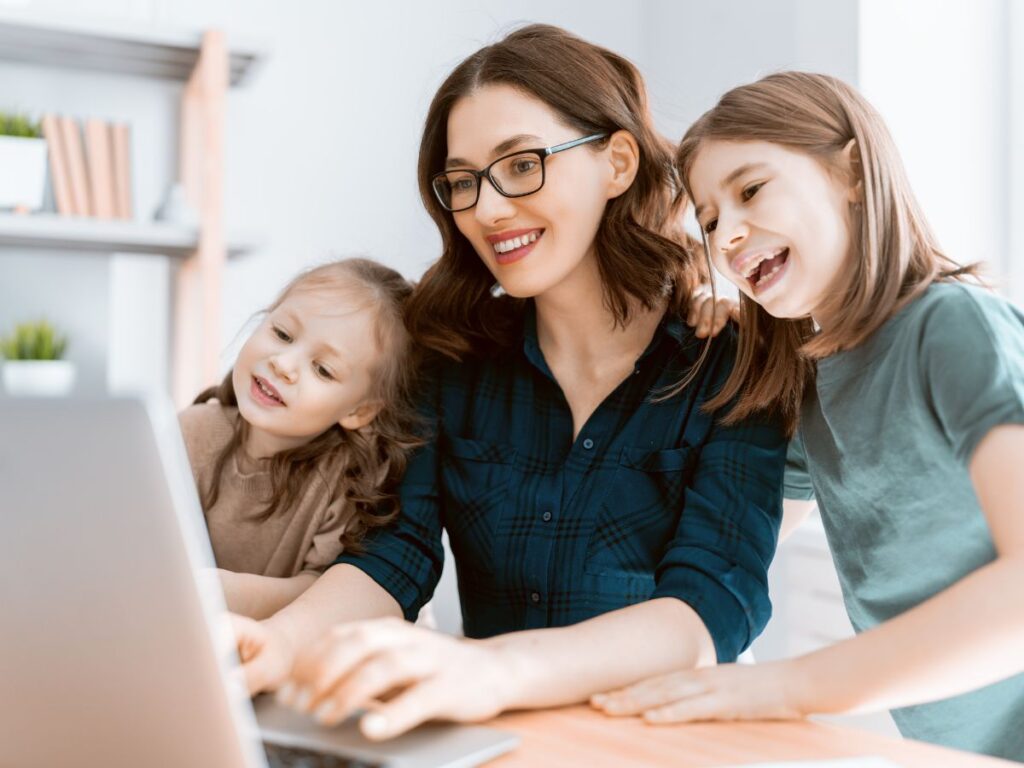 mom blogging with kids around her